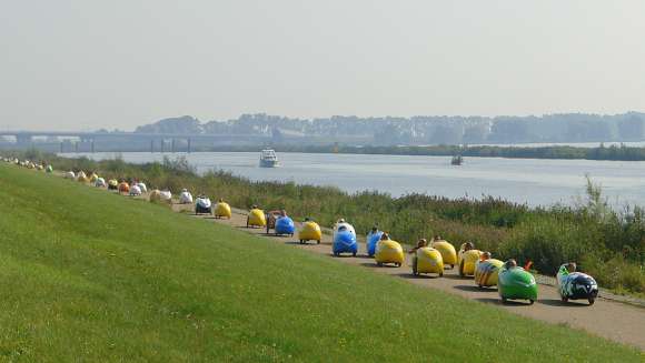 Photo of a row of velomobiles on tour